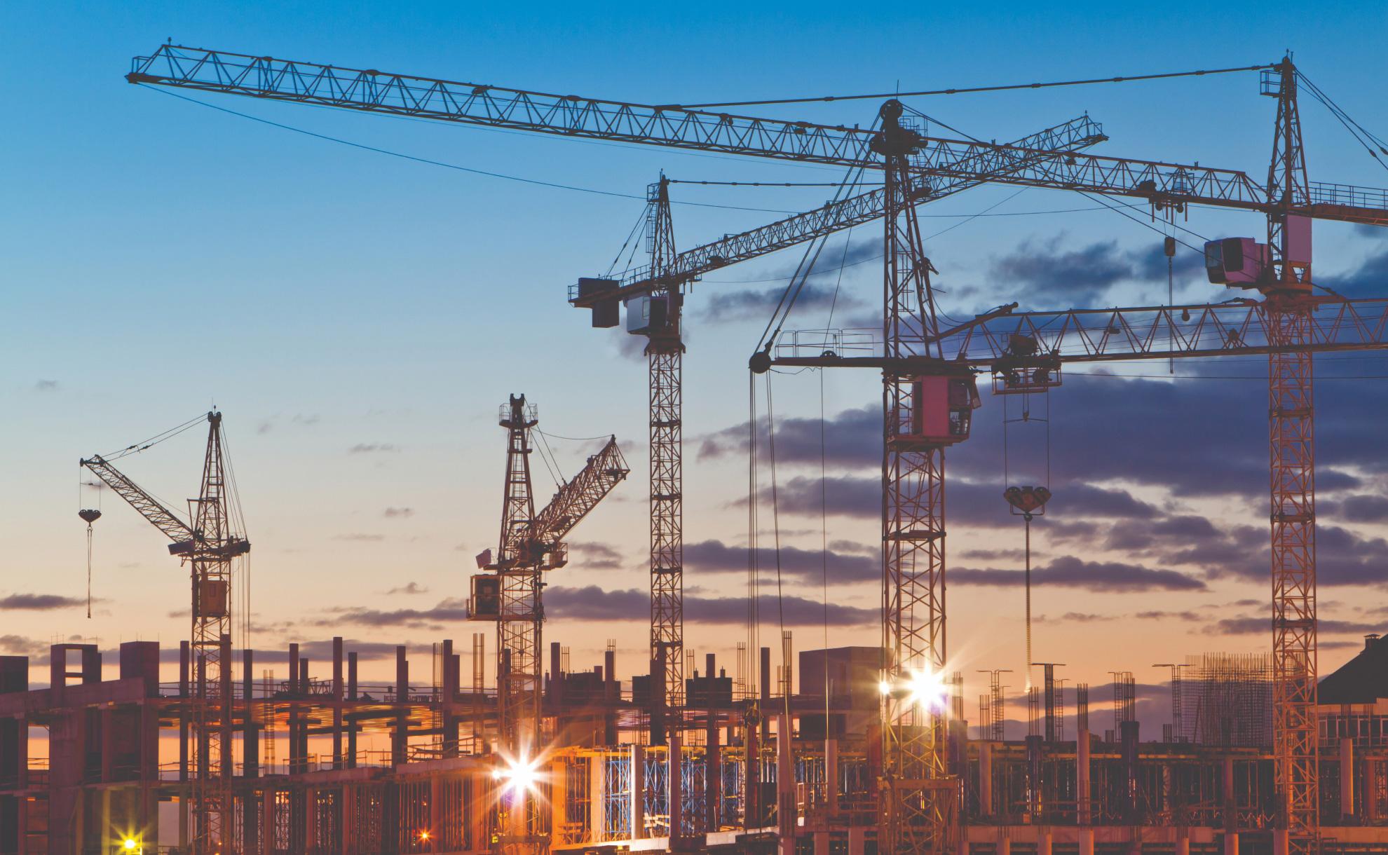 Various cranes at sunset
