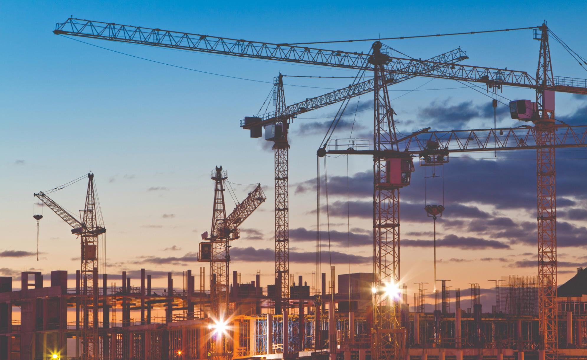 Various cranes at sunset