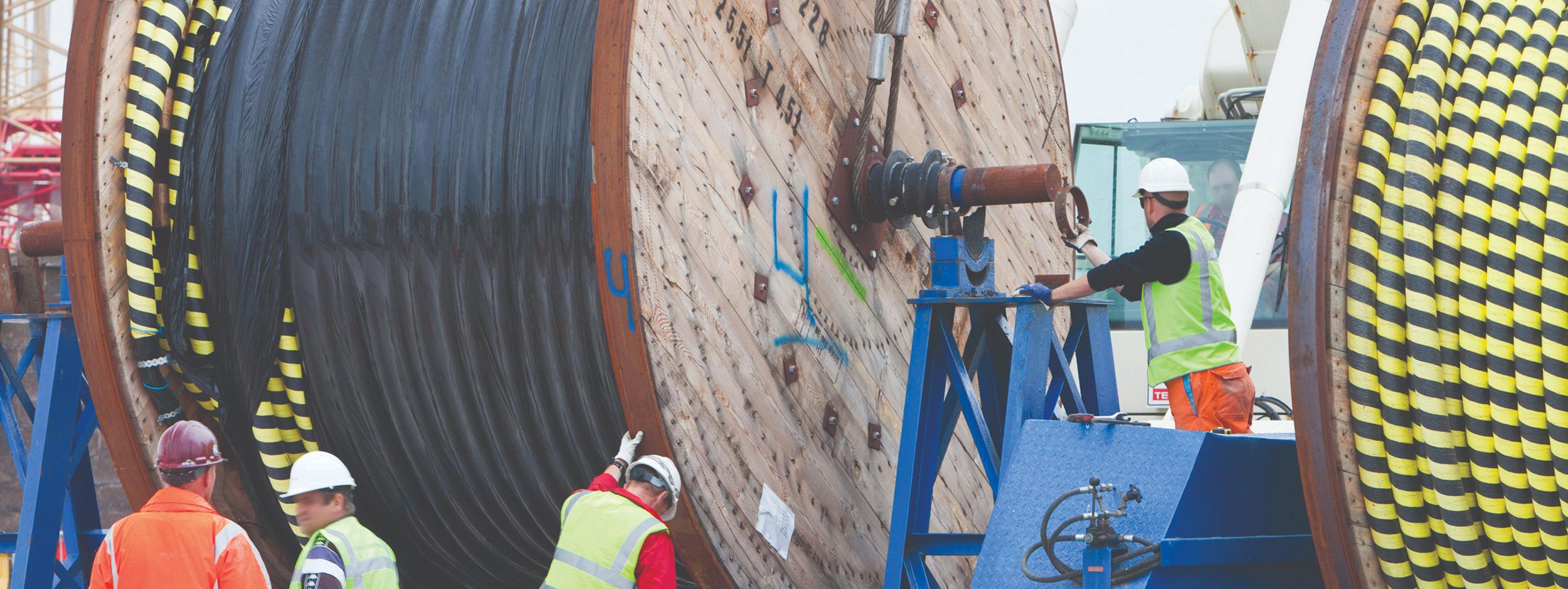 Cable drum being mounted on a drum stand