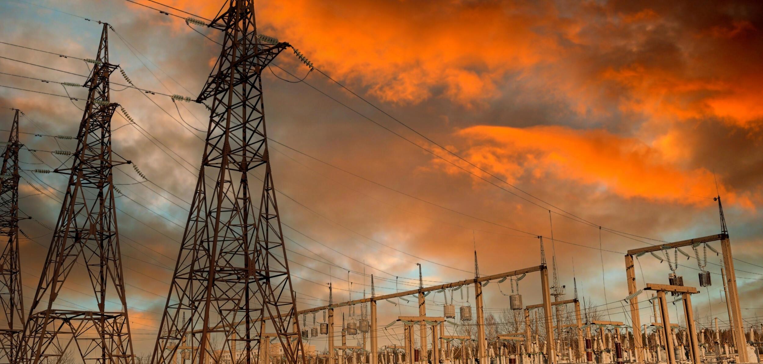 Electricity pylons and substation at sunset
