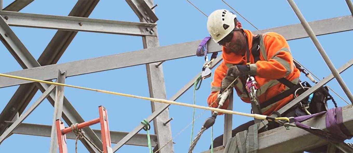 Linesman working at height on an electricity pylon