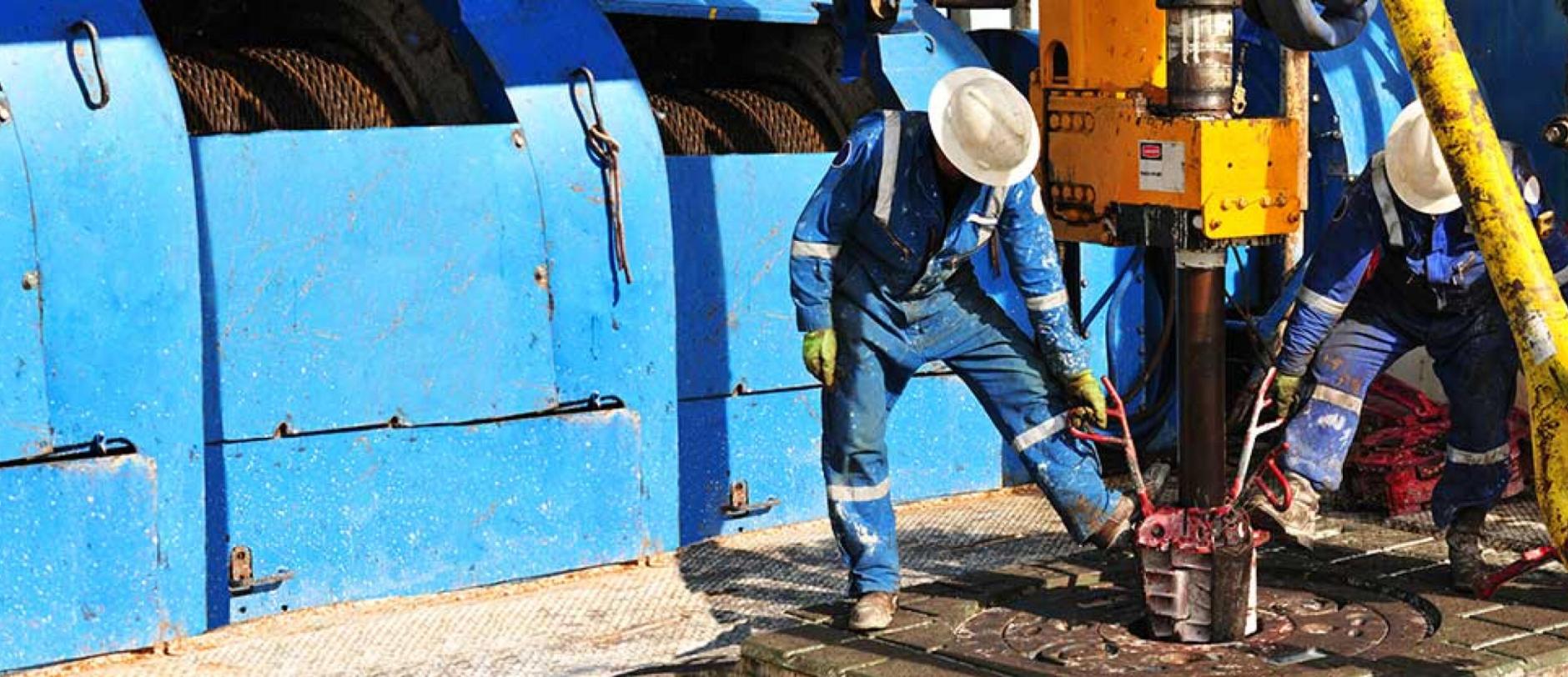 Rig workers on the drill floor of an oil rig