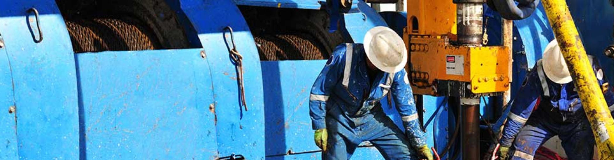 Rig workers on the drill floor of an oil rig