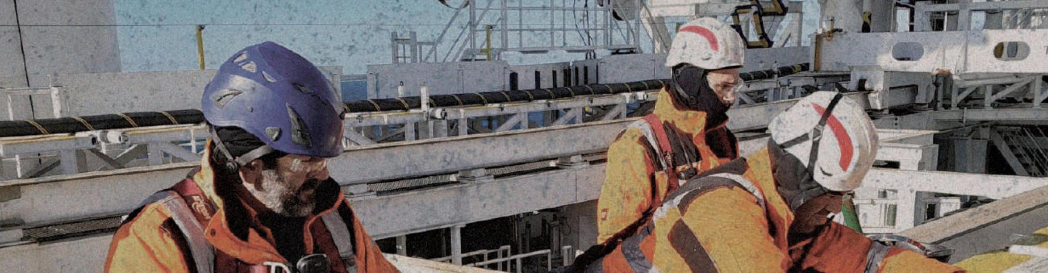 Offshore crew working with a cable grip on deck