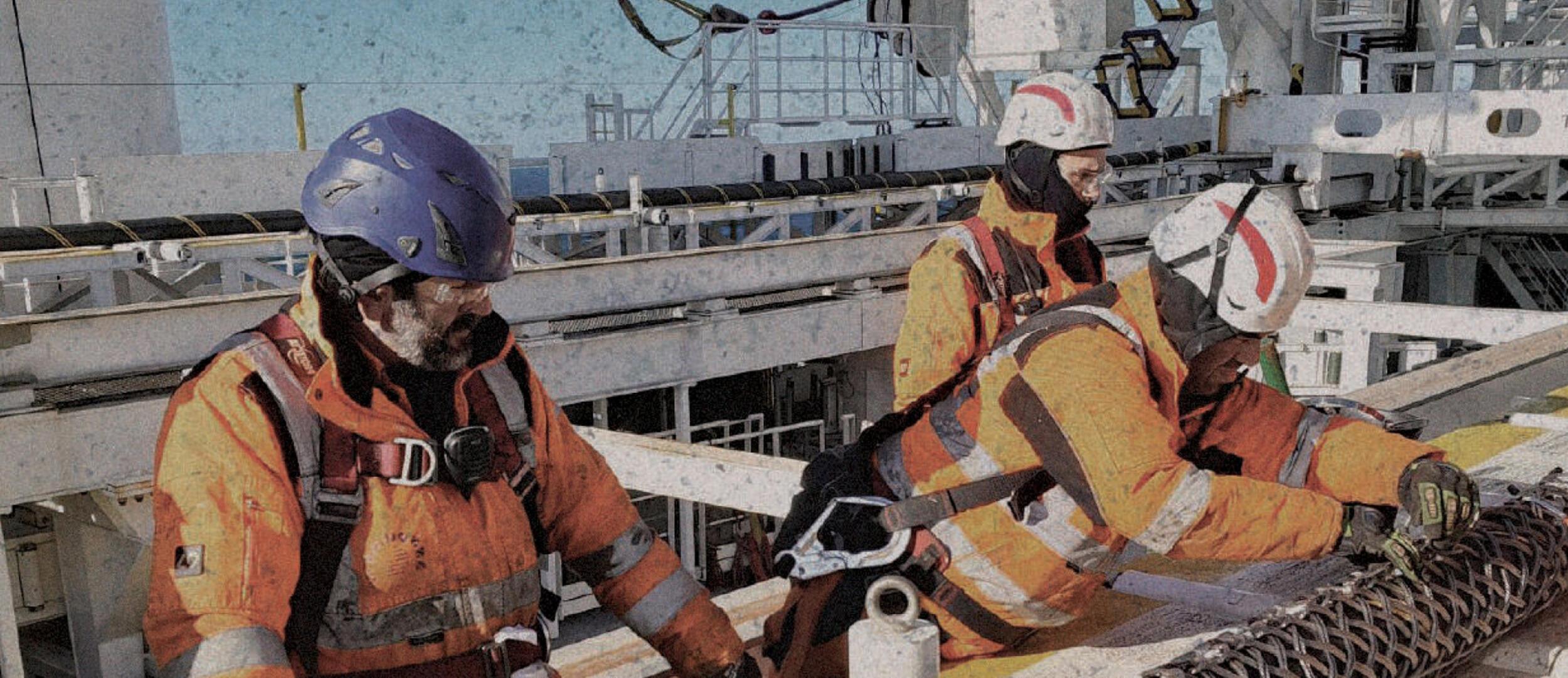 Offshore crew working with a cable grip on deck