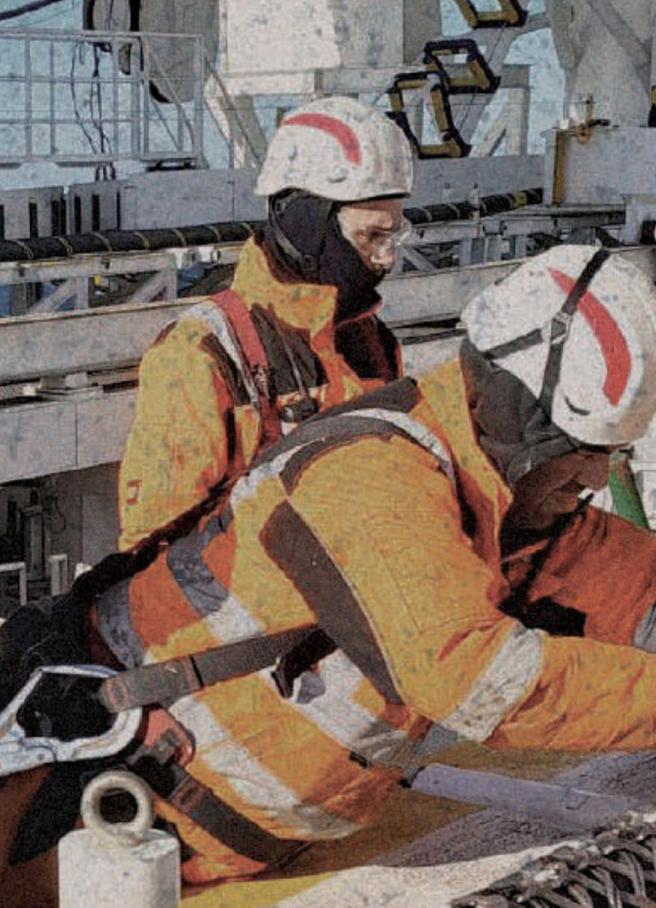 Offshore crew working with a cable grip on deck