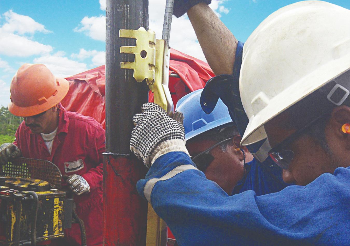 Drilling crew handling pipe on a rig
